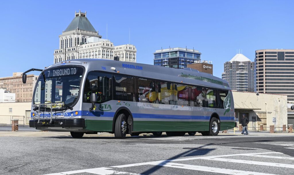 A Greensboro Transit Authority electric bus turns onto East Washington Street. Greensboro was the first community in North Carolina to put battery-powered, zero-emission buses in regular, daily route service.