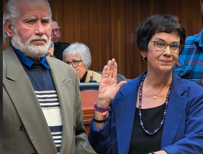 Greensboro Councilwoman Marikay Abuzuaiter was sworn in as mayor pro tem on Tuesday as her husband Isa, seen to her left, and other family members stood by her side. KEVIN GRIFFIN, NEWS & RECORD