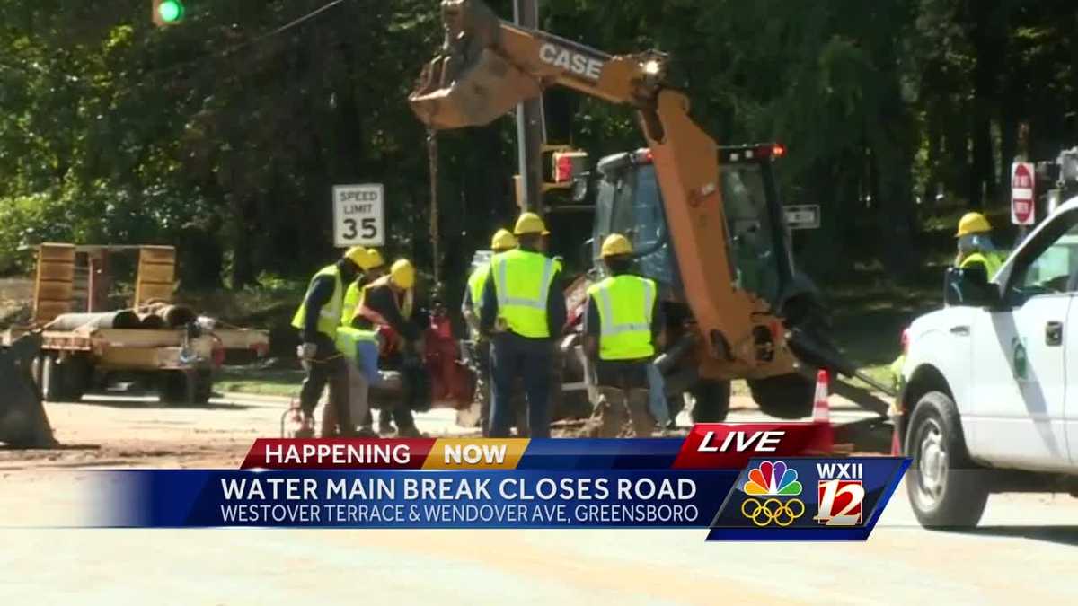 Road Reopens After Water Main Break in Greensboro: Crews working to repair a major water main break, with traffic cones and heavy machinery visible—highlighting the aging and vulnerable water infrastructure that disrupts daily life.